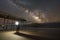 Man exploring a damaged pier at night