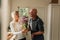 Man expressing his love for his wife giving her a bunch of flowers at home. Senior woman happy to see her husband give her a