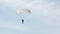 Man extremely descends with a parachute to the ground. Parachute flight