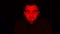 Man Face in Dark, with Red Glowing Light, Facial Expressions. Portrait of Devil, Scary Concept
