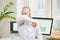 A man in a face mask against the coronavirus coughing in the bend of his elbow