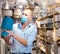 Man in face mask choosing table lamps in store