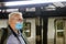 Man in face mask for Covid-19 subway station coronavirus epidemic pandemic on train metro tube male health care