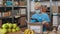 Man in face mask using tablet while packing donation box