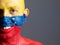 Man face painted with venezuelan flag, smiling expression