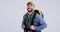 Man, face and travel with backpack, freedom and adventure for camping with smile in studio. Male person, portrait and