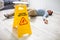 Man Falling On Wet Floor In Front Of Caution Sign