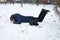 A man falls in the snow. The man slipped and was injured. Falling on ice. Winter. Fracture, bruise, dislocation