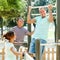 Man with family training on chin-up bar