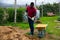 Man farmer with barrow during working with fertilizers