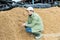 Man farmer checking quality of beer bagasse