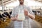 Man or farmer with cows milk on dairy farm