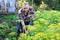 Man farmer digging in his estate garden