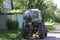 Man farmer filling the fuel tank of the tractor parked near his household. Mena, Chernigivska oblast, Ukraine