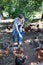 Man farmer giving feeding stuff to chickens