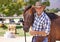 Man, farmer and happy with horse in ranch for care with bonding, feeding and support in Texas. Mature, male person and