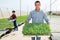 Man farmer puts cassette with seedlings of seedlings in row