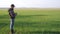 Man farmer red neck with a digital tablet lifestyle walks on a green field. Eco smart farming agriculture concept. Male