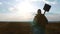 Man farmer silhouette red neck holding a shovel in his hand walking across the field a pile of dirt soil. Eco smart