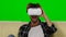 Man fascinated by the movie in VR the mask. Green screen