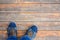 Man in fashion sneakers stands on an old wooden floor. Copy spas