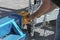 Man fastening a chain onto an industrial hitch on a trailer - close-up