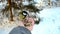 Man feeding birds with his hands in the park in winter