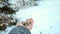 Man feeding birds with his hands in the park in winter