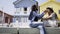 Man feeding girlfriend near colorful buildings