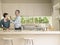 Man Feeding Wife At Kitchen Counter