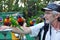 Man feeding wild Australian Rainbow Lorikeets