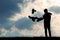 Man feeds the pigeons at sunset