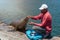 A man feeds a seal in Hout Bay in Cape Town