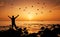 Man feeling freedom on beach during sunrise