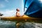 Man feeling the sun light on his face when he sails in canoe in