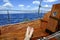 Man feet relax on golden wooden old sailboat