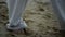 Man feet taking steps on sand closeup. Barefoot sportsman training on beach.