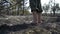 Man feet walking by burned forest, dangeroud drought weather, ash, ecology disaster catactrophe