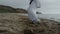 Man feets stepping on beach sand practicing karate overcast weather close up.