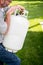 Man fiddles with a propane bottle in the backyard