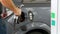 Man filling car with Diesel Fuel. Man`s hand using a petrol pump to fill his car up with fuel.