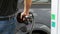 Man filling car with Diesel Fuel. Man`s hand using a petrol pump to fill his car up with fuel.