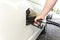 Man filling car with diesel. Hand with black oil dispenser at gasoline station. Refueling old minivan euro3 with diesel