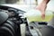 Man filling car radiator with antifreeze outdoors, closeup