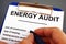 Man filling in energy audit form in a clipboard.