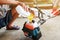 Man is filling fuel Into the fuel tank of Lawn mower