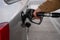 Man filling fuel tank of his car with diesel fuel at the gas station close up, as cost of fuel going up