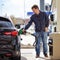 Man filling gasoline fuel in car