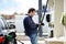 Man filling gasoline fuel in car