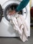 Man filling laundry in the washing machine